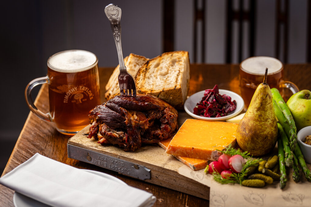 Sharing cheeseboard with bread, chutney and a pint of beer at The Tallyman.