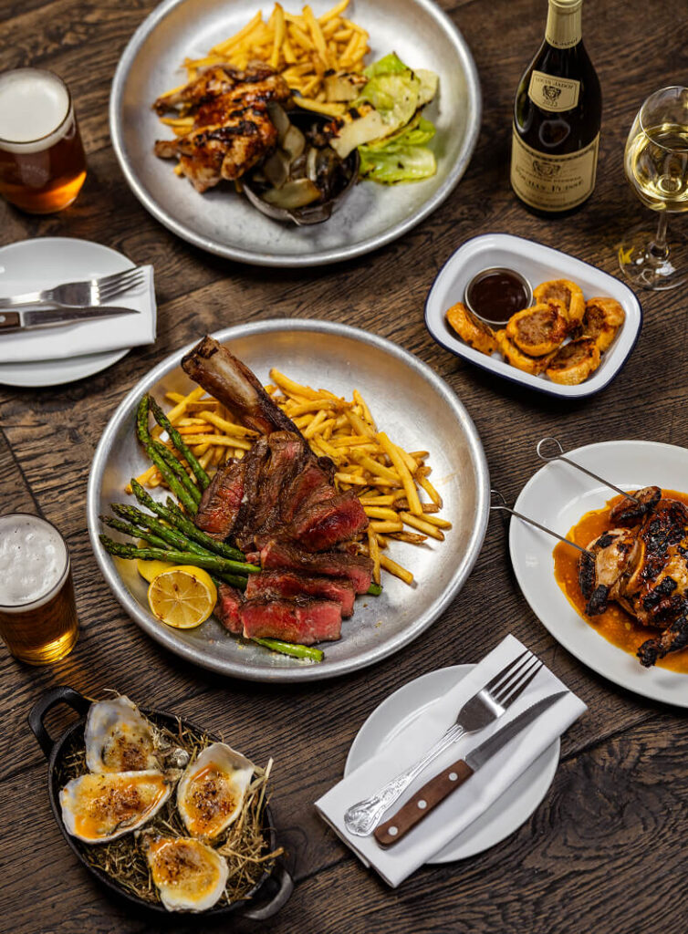 Sharing plates and pub food laid out on a dining table at The Tallyman.