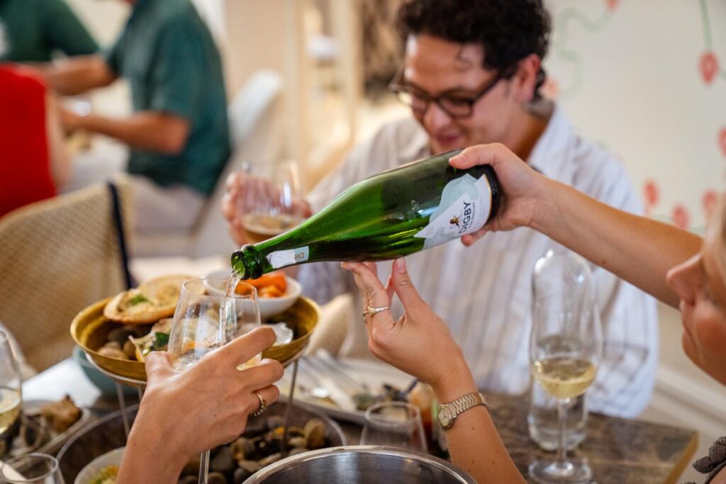 Women pouring a glass of Digby Fine English Sparking Wine.