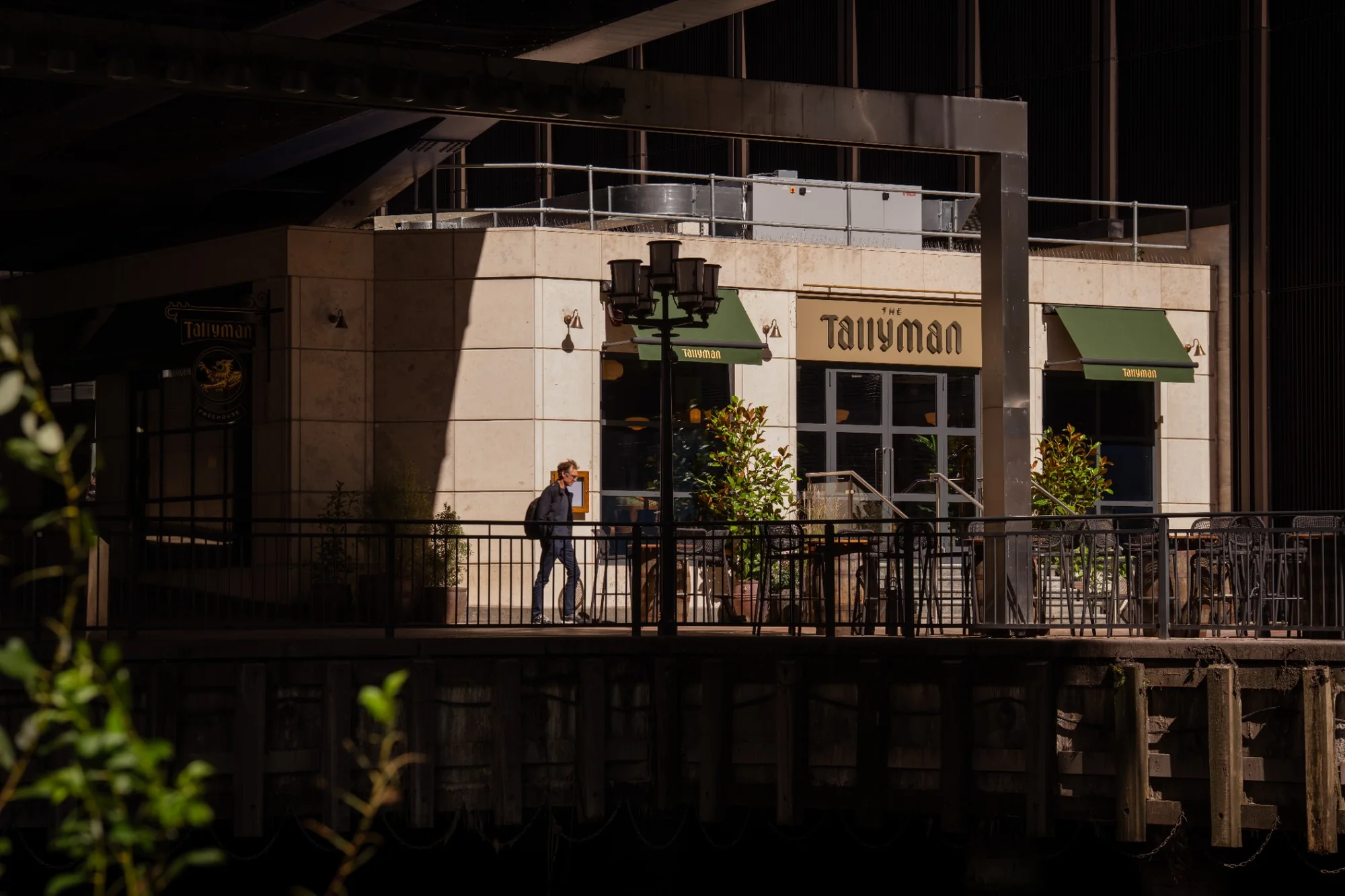 The Tallyman exterior with outdoor seating beneath the surrounding buildings.