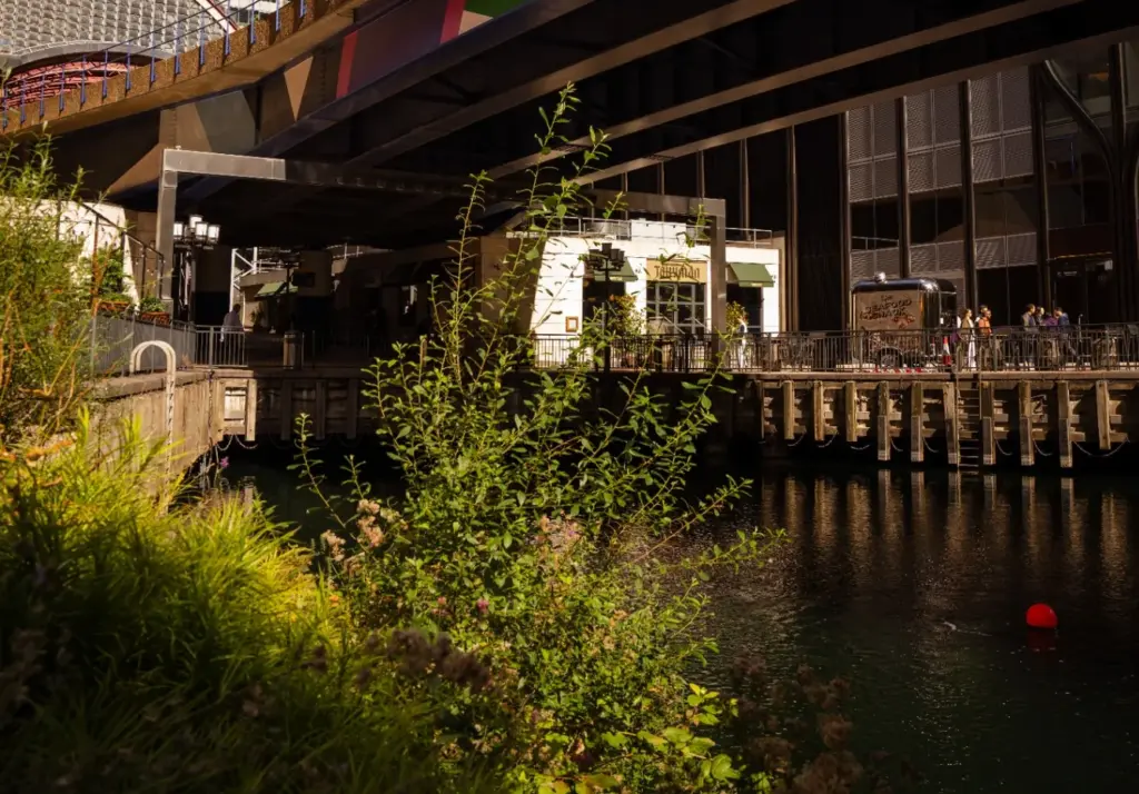 The Tallyman exterior beneath an elevated structure with greenery in the foreground.