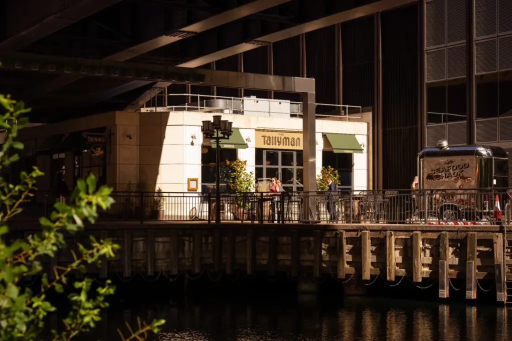 The Tallyman exterior with outdoor seating beneath the surrounding buildings.