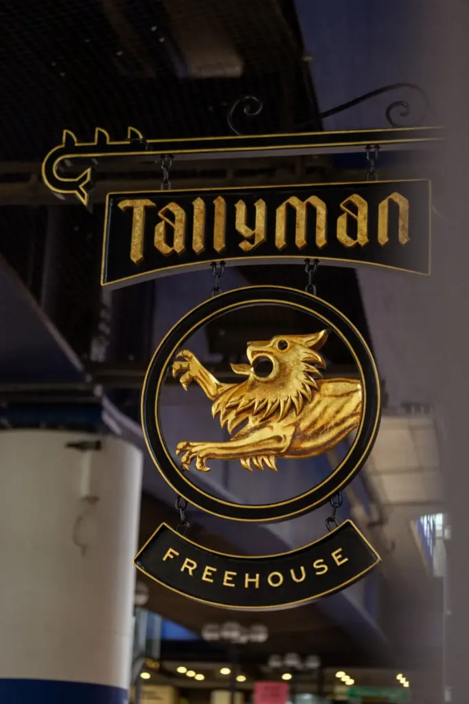 Tallyman Freehouse hanging pub sign featuring a gold emblem.