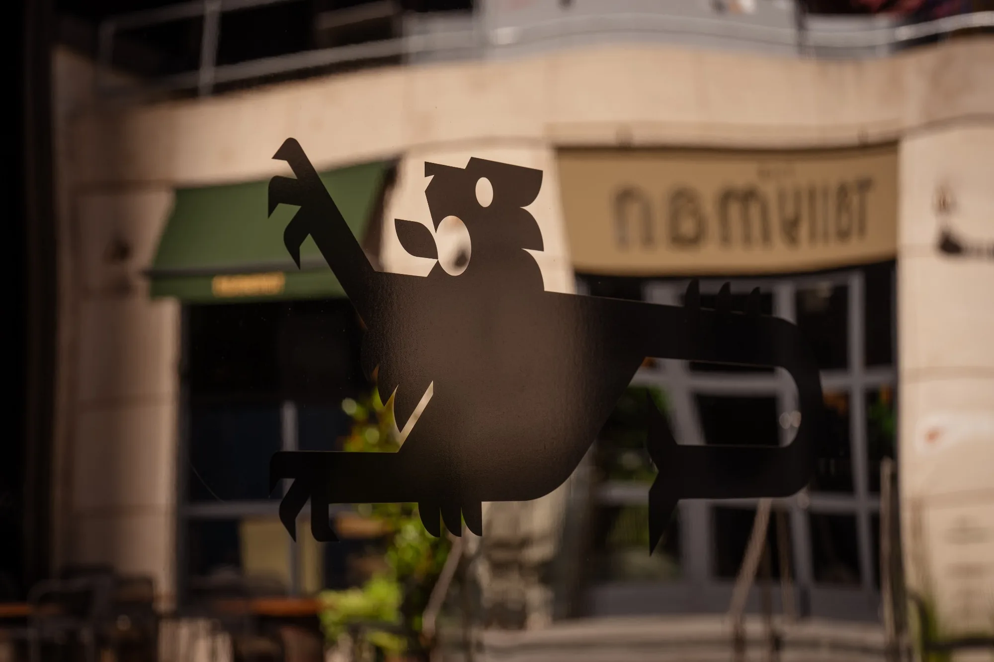 Tallyman logo detail on a sign with the venue exterior blurred behind.