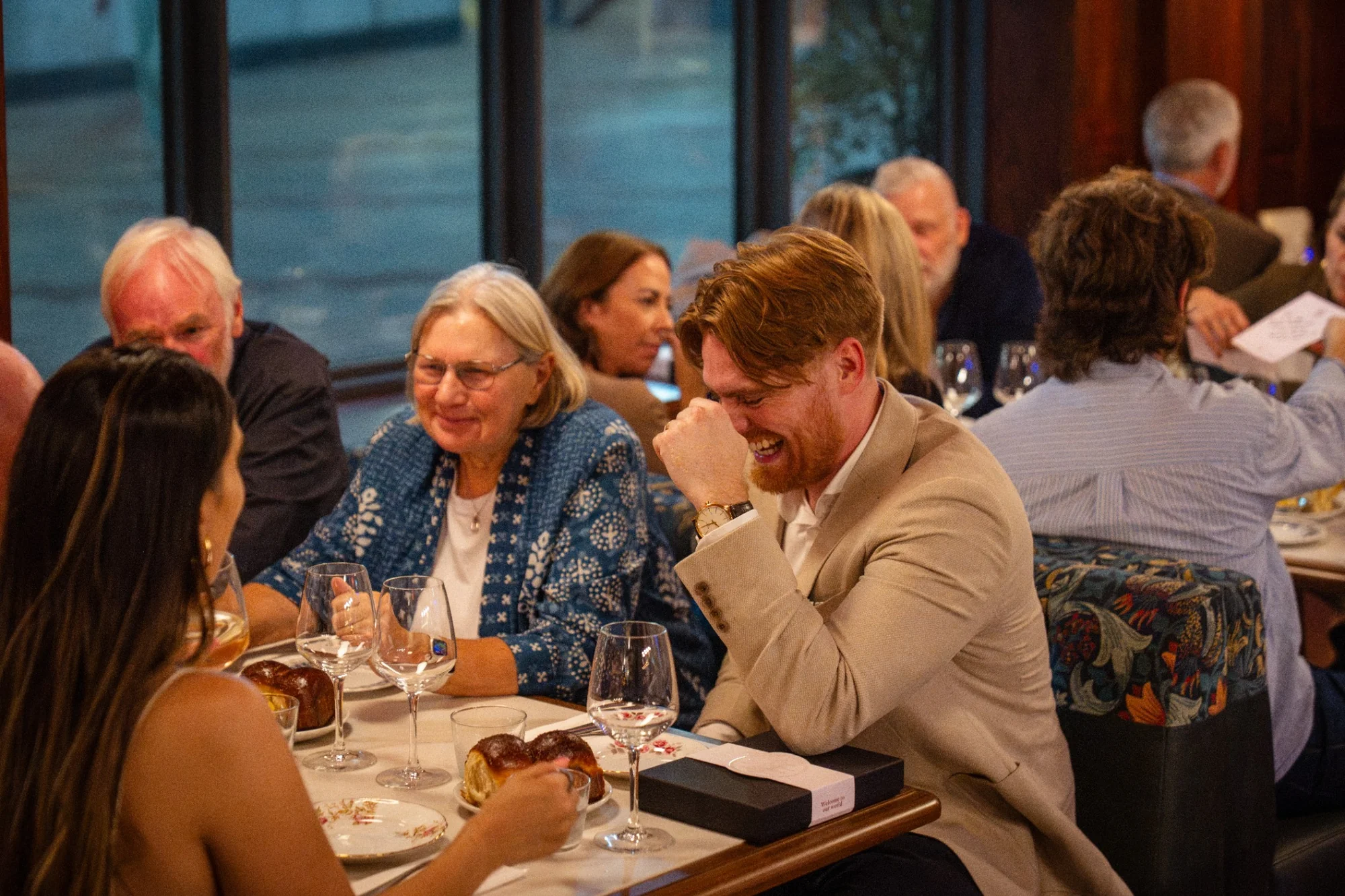 Guests seated together around a dining table at The Tallyman.